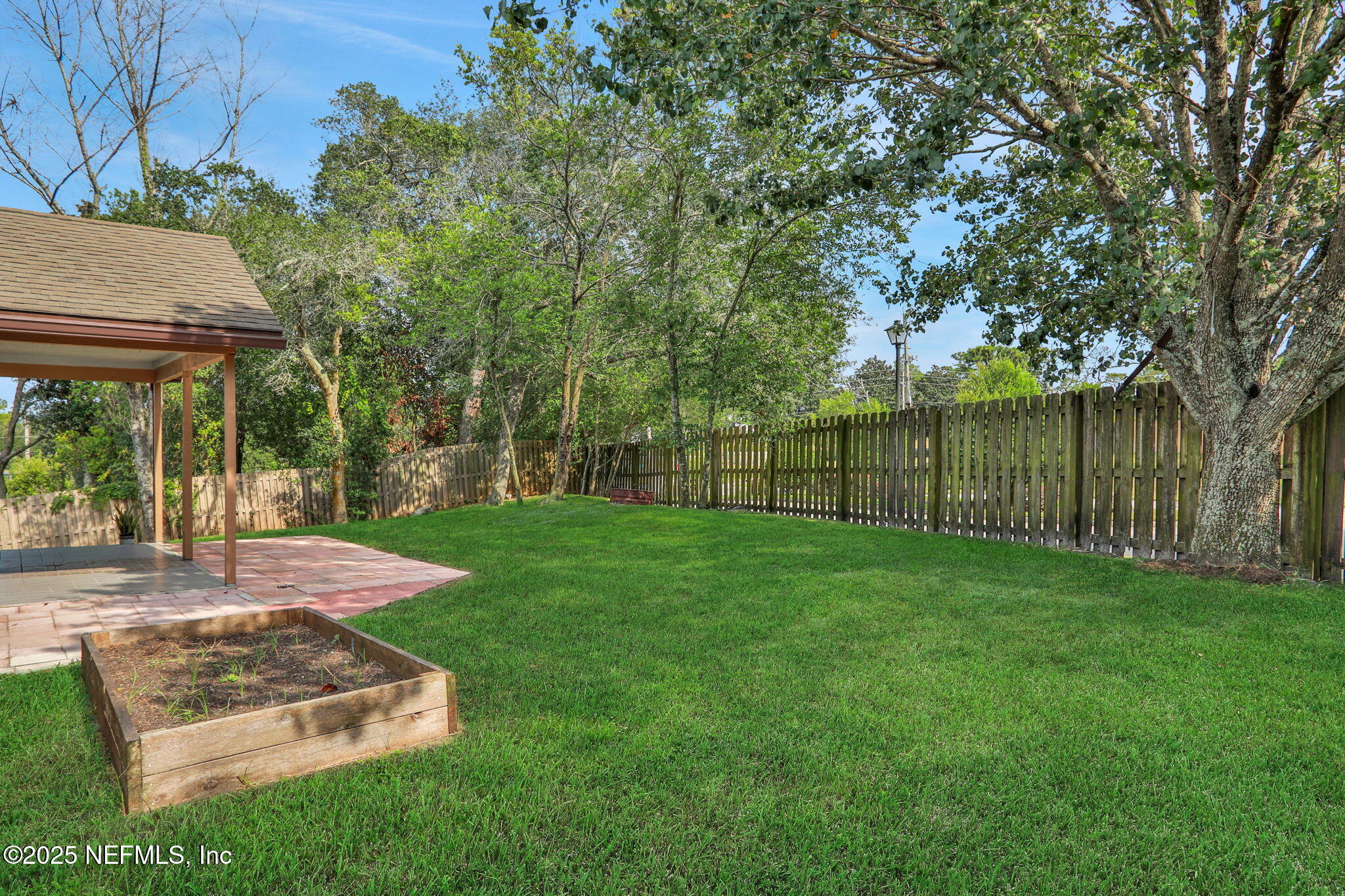 12228 Smoke Ridge Circle South Jacksonville, FL 32225 - Photo 45 of 50 a view of a backyard with a garden