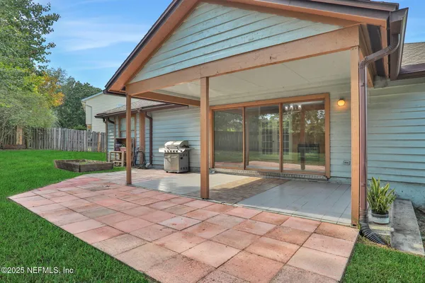 a view of a house with backyard porch and sitting area