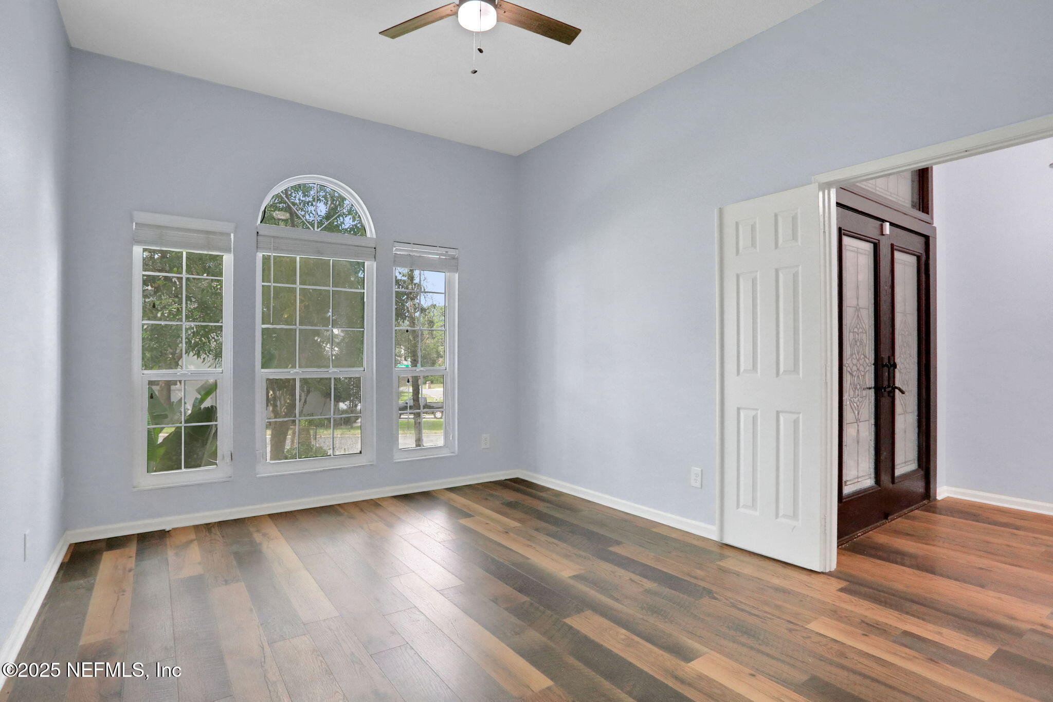 12228 Smoke Ridge Circle South Jacksonville, FL 32225 - Photo 6 of 50 a view of an empty room with wooden floor and a window