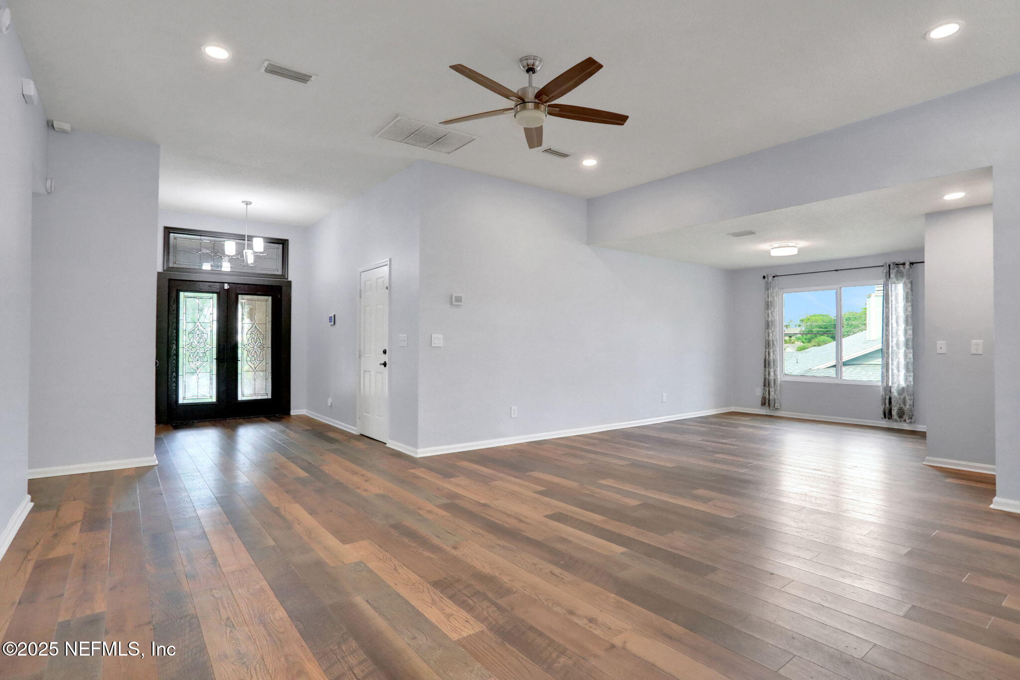 12228 Smoke Ridge Circle South Jacksonville, FL 32225 - Photo 8 of 50 an empty room with window and wooden floor