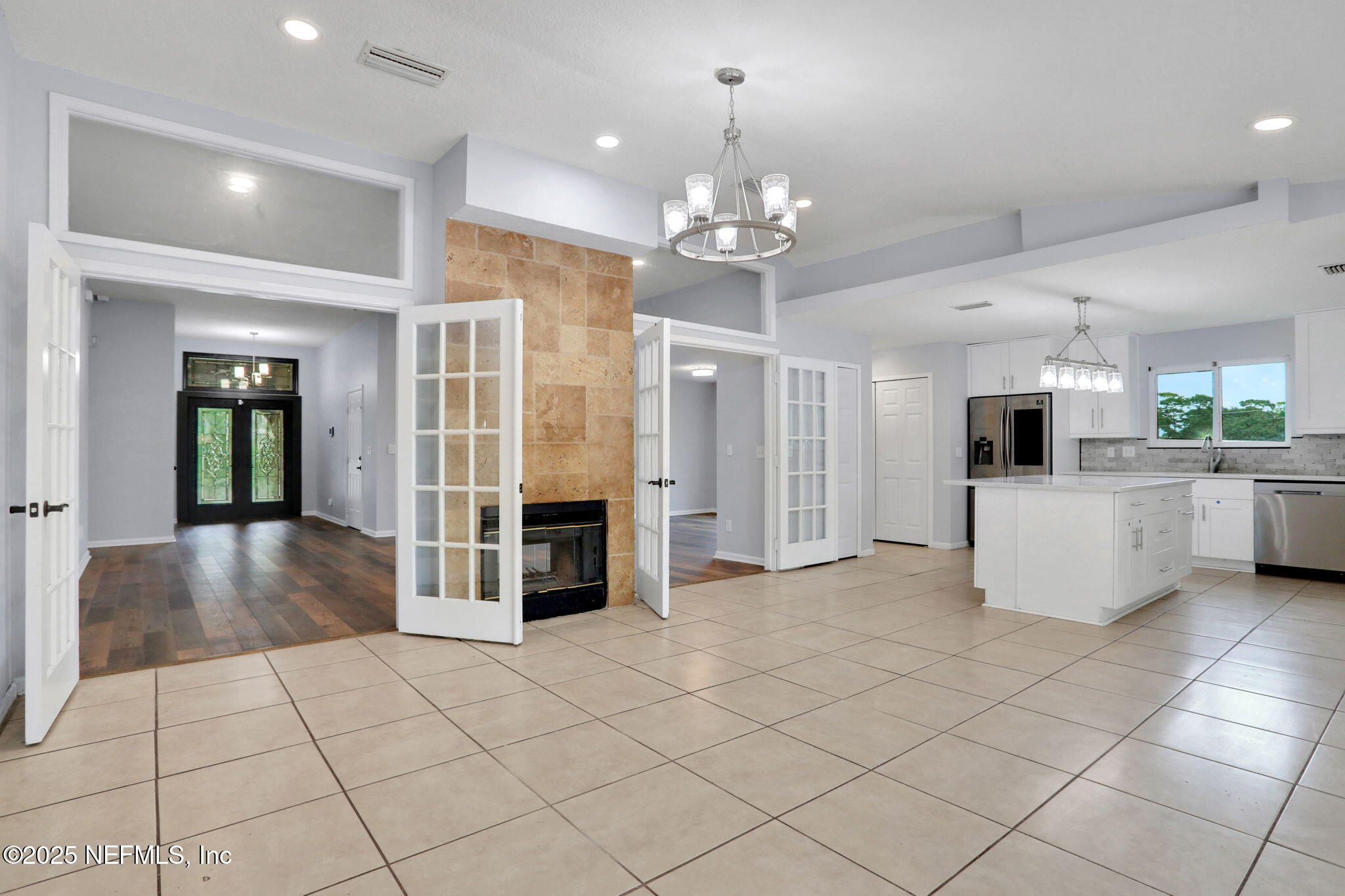 12228 Smoke Ridge Circle South Jacksonville, FL 32225 - Photo 9 of 50 a view of a livingroom with kitchen and chandelier