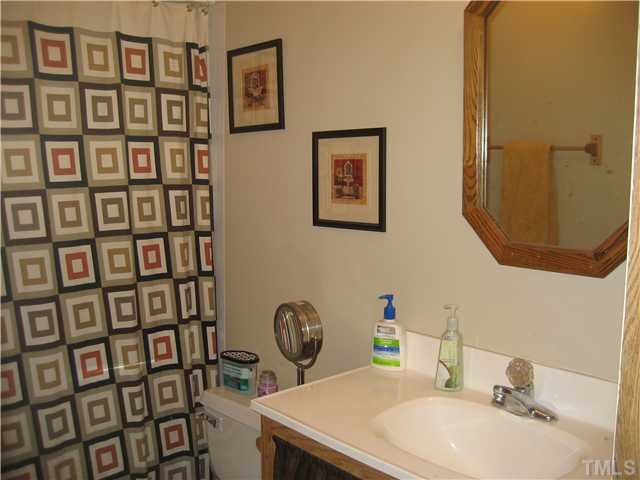 7500 Rock Service Station Road Raleigh, NC 27603 - Photo 15 of 21 Hall Bath with new flooring and new light fixture.