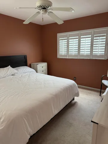 a bedroom with bed and window