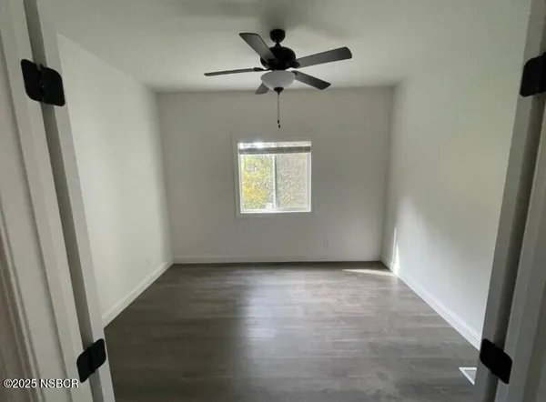 a view of an empty room and a window