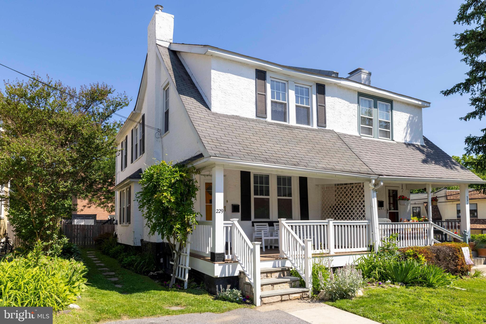 229 Wayne Avenue Narberth, PA 19072 - Photo 2 of 35 a front view of a house with a yard table and chairs