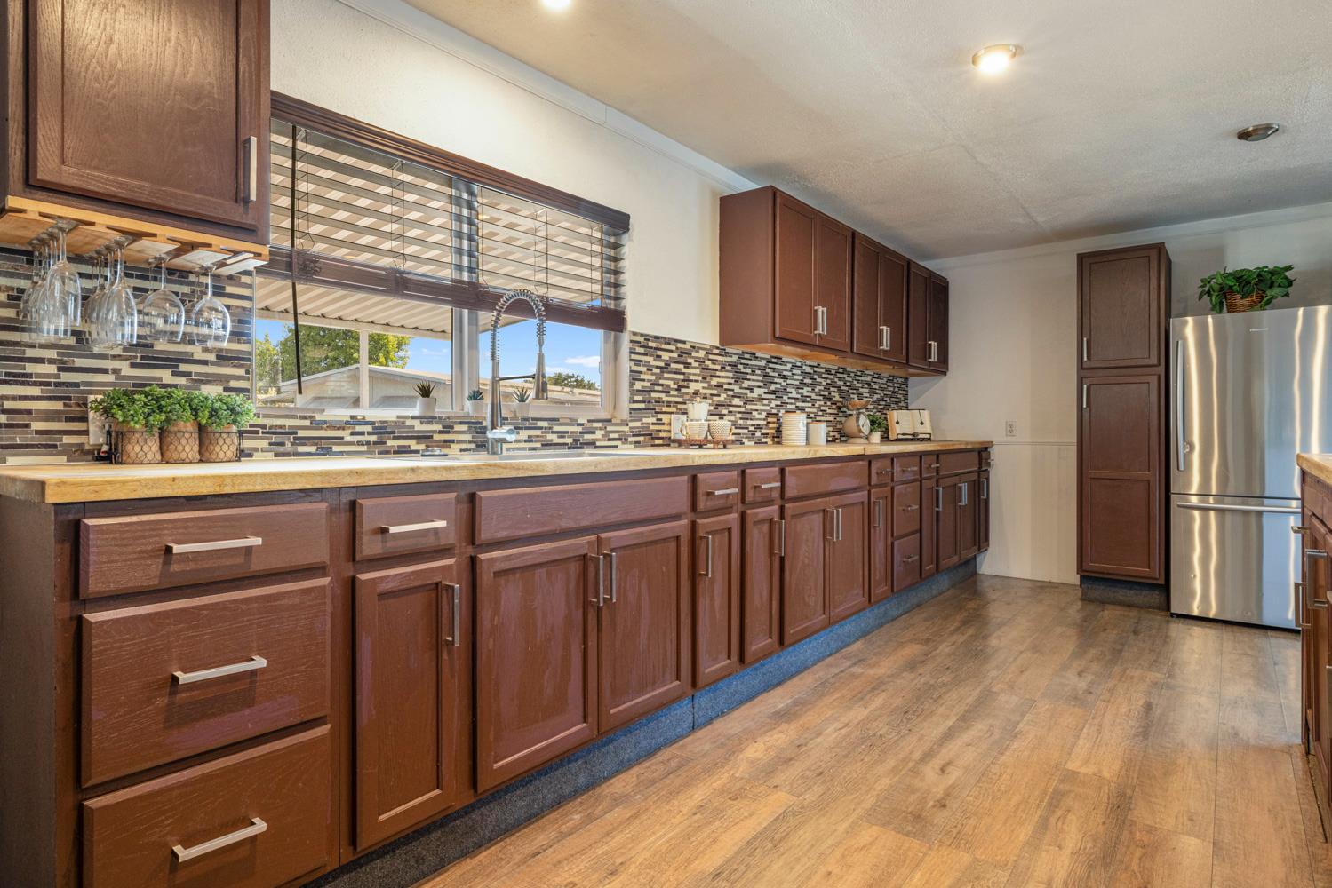 2621 Prescott Road, Unit 79 Modesto, CA 95350 - Photo 22 of 41 a kitchen with stainless steel appliances granite countertop a sink cabinets and wooden floor