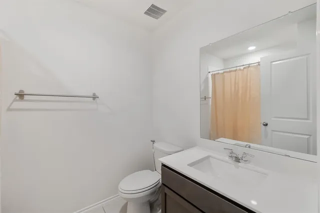 a bathroom with a sink toilet and vanity