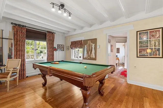 a room with pool table and windows