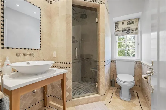 a bathroom with a sink toilet and shower