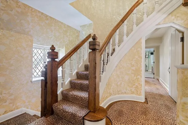 a view of entryway and hall with wooden floor