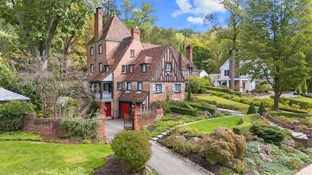 an aerial view of a house with a yard and plants