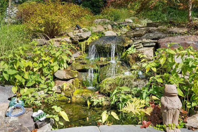 a view of backyard of house with outdoor seating