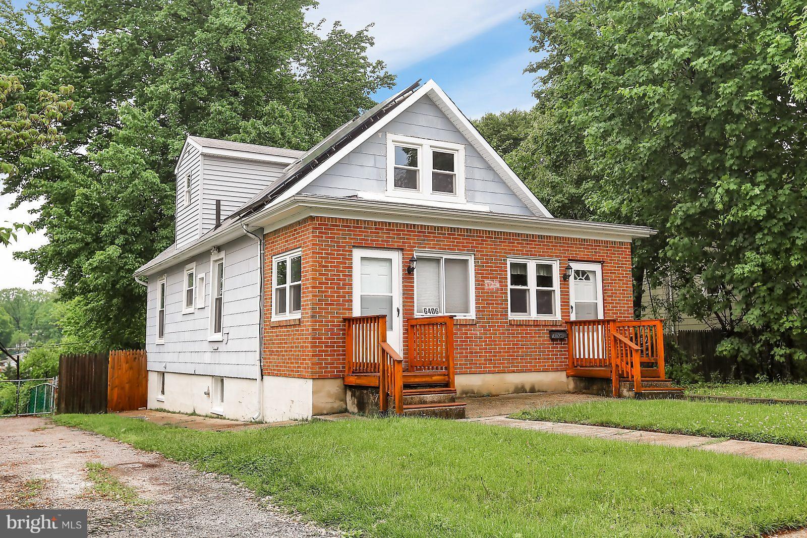 6406 Sherwood Road Baltimore, MD 21239 - Photo 1 of 25 a front view of a house with a yard