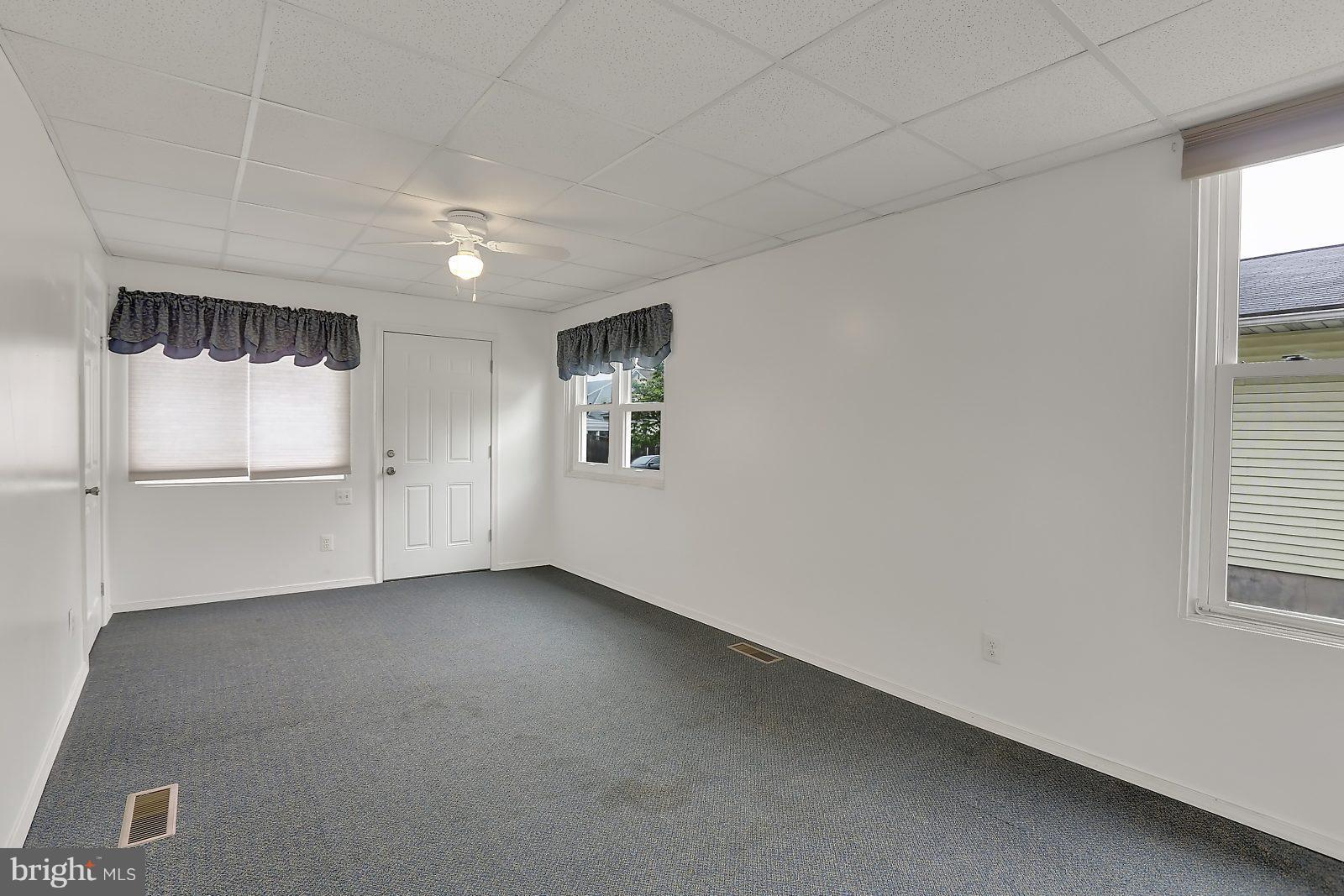 6406 Sherwood Road Baltimore, MD 21239 - Photo 13 of 25 an empty room with windows and closet