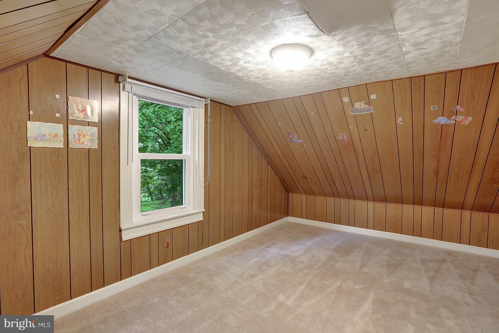 6406 Sherwood Road Baltimore, MD 21239 - Photo 18 of 25 a view of a room with a window and a ceiling fan