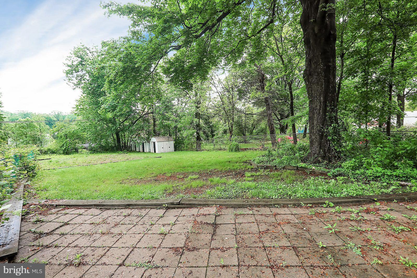 6406 Sherwood Road Baltimore, MD 21239 - Photo 20 of 25 a view of a garden with trees