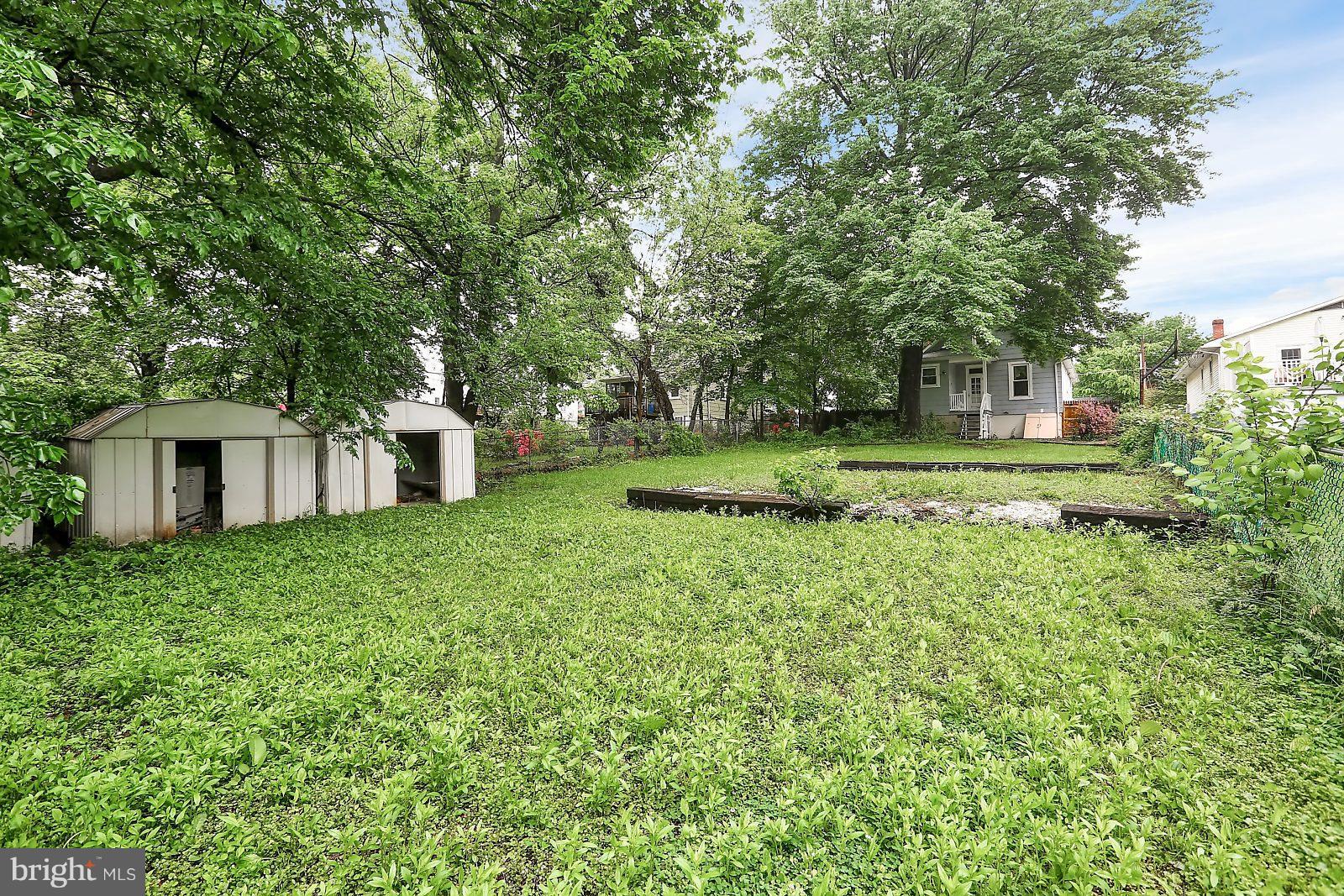 6406 Sherwood Road Baltimore, MD 21239 - Photo 21 of 25 a view of a house with a yard and sitting area