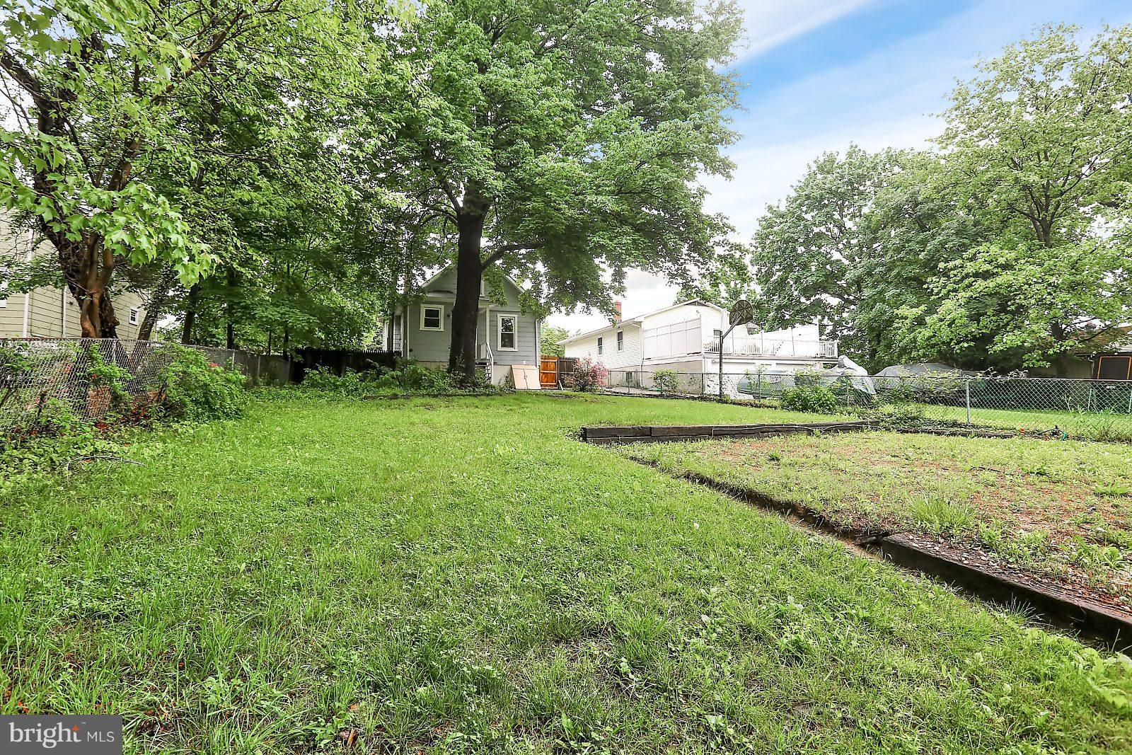 6406 Sherwood Road Baltimore, MD 21239 - Photo 22 of 25 a view of a park with large trees