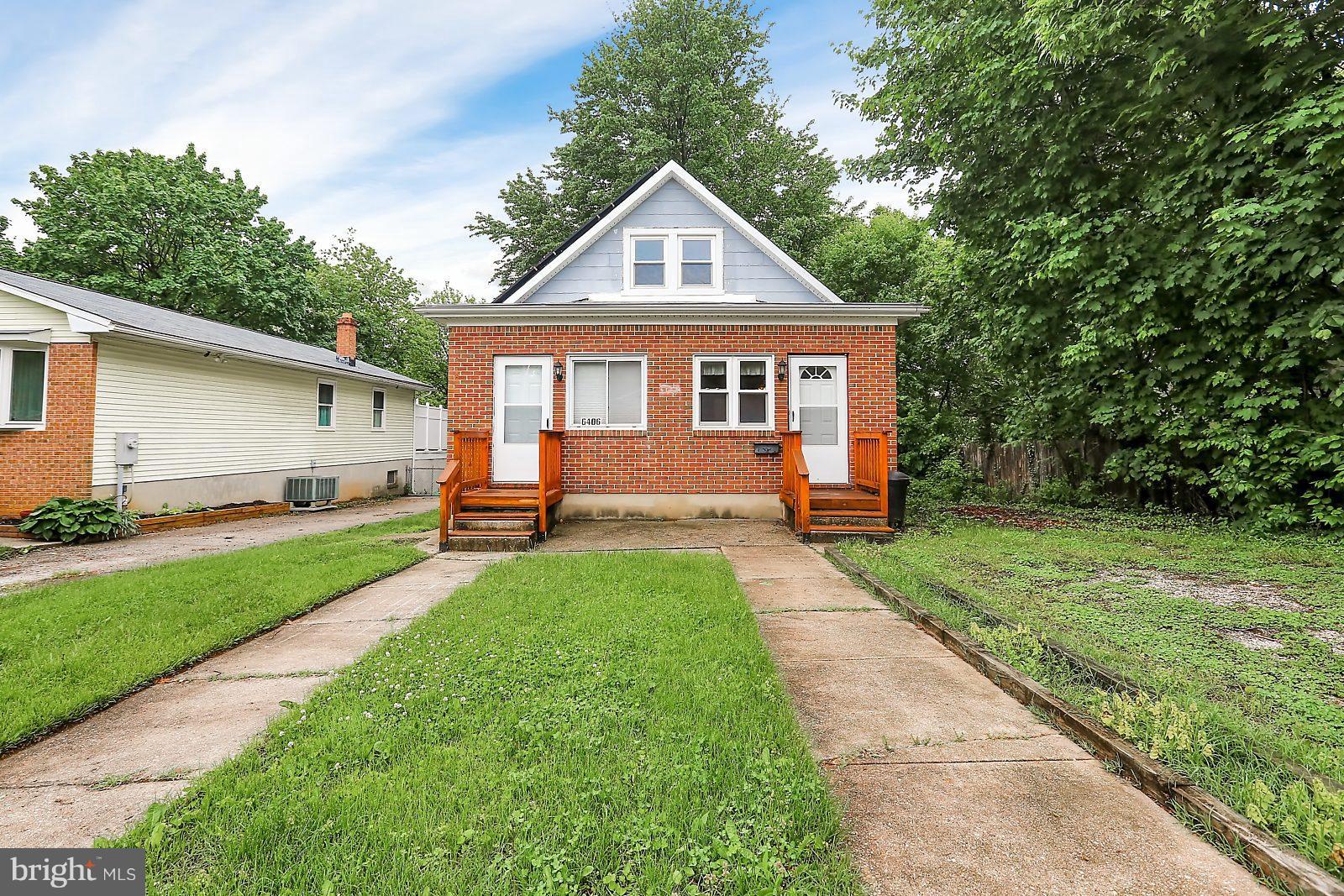 6406 Sherwood Road Baltimore, MD 21239 - Photo 24 of 25 a front view of a house with a yard