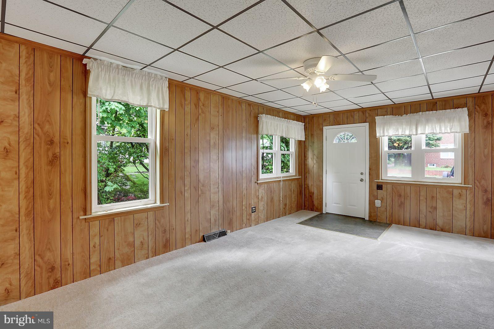 6406 Sherwood Road Baltimore, MD 21239 - Photo 4 of 25 a view of an empty room with a window