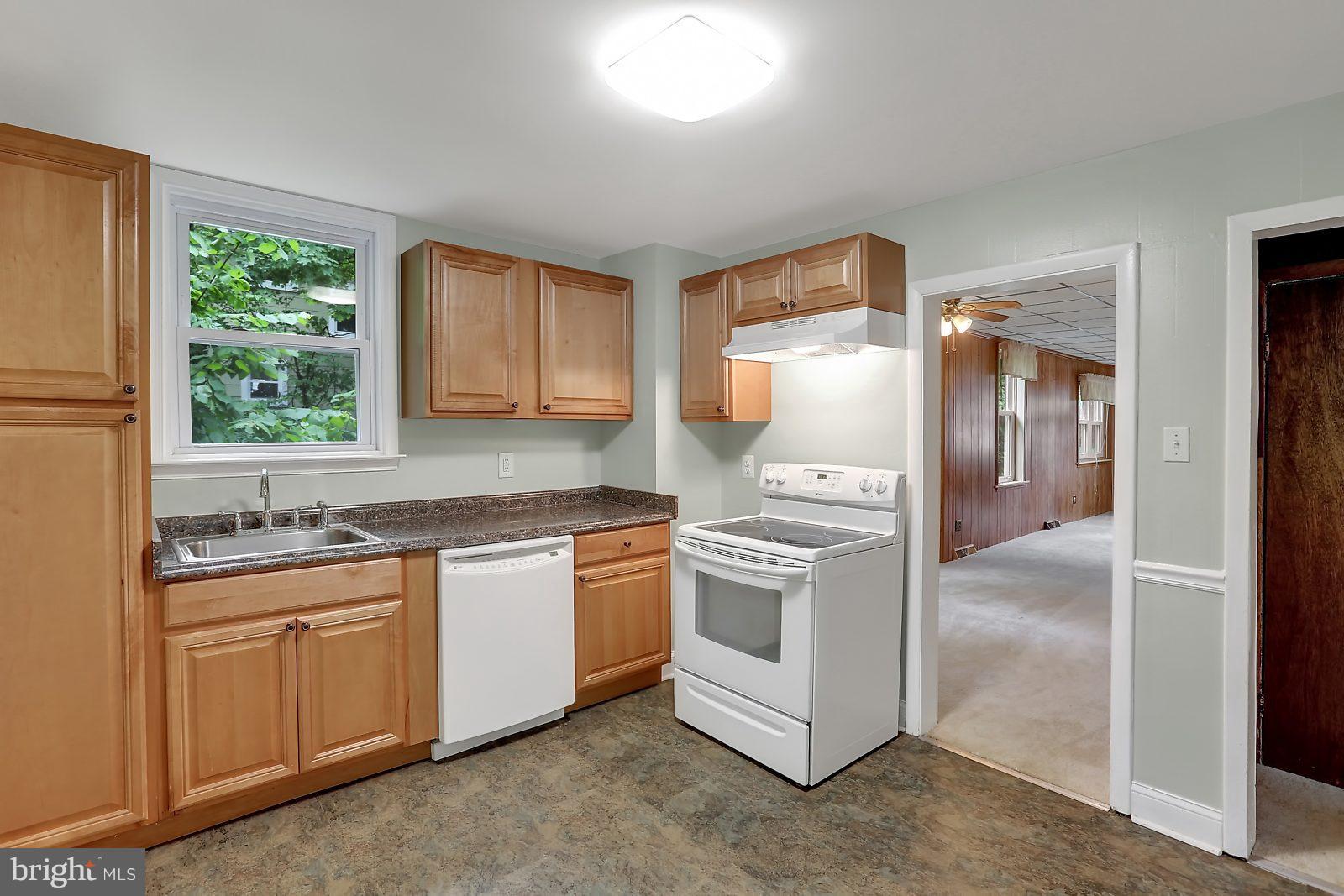 6406 Sherwood Road Baltimore, MD 21239 - Photo 8 of 25 a kitchen with stainless steel appliances granite countertop a sink and a refrigerator