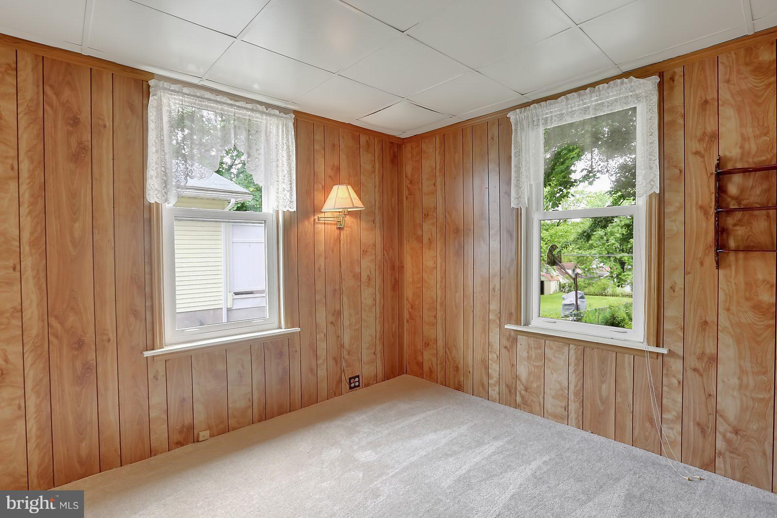 6406 Sherwood Road Baltimore, MD 21239 - Photo 10 of 25 an empty room with windows