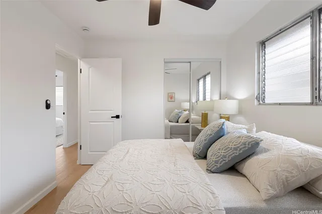 a bedroom with a bed a window and couch