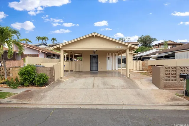 a view of a house with a garage and yard