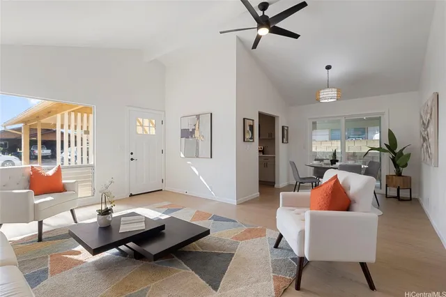 a living room with furniture and wooden floor