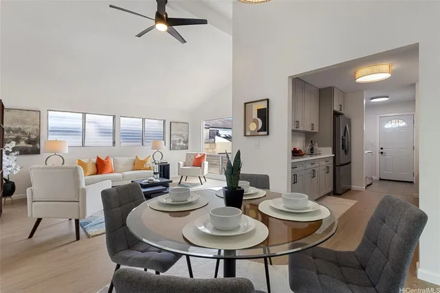 a dining room with furniture and a large window