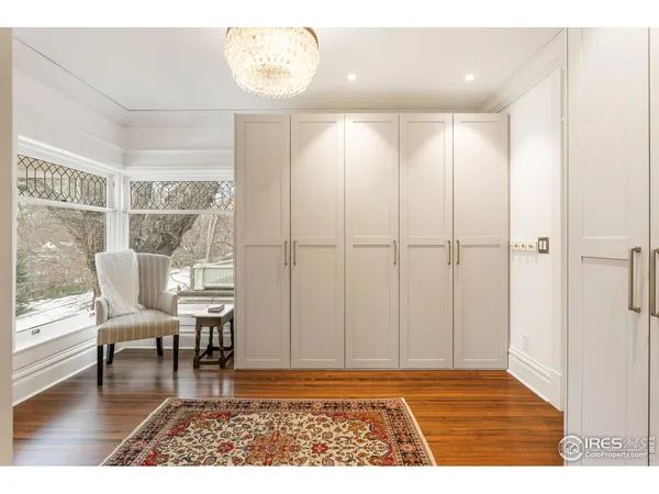 a view of a livingroom with furniture wooden floor and a window
