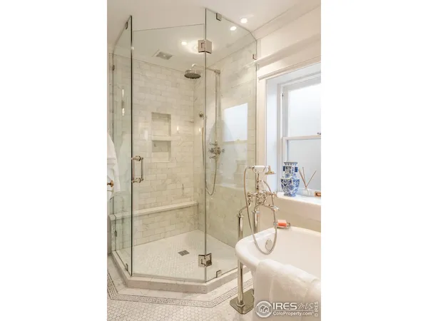 a bathroom with a granite countertop shower a mirror and a sink