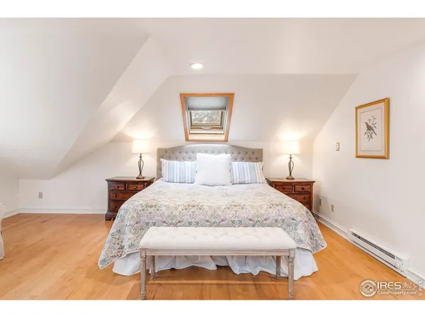 a bedroom with a bed and a night stand