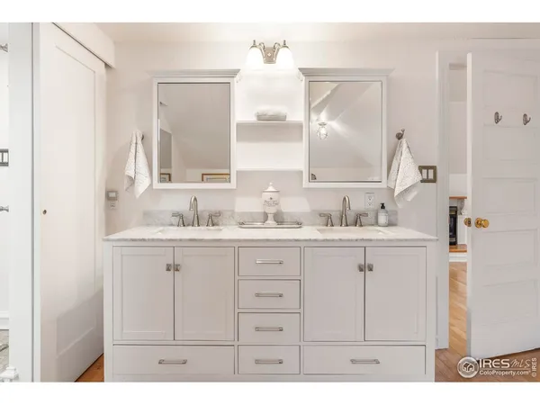 a bathroom with a sink vanity and mirror