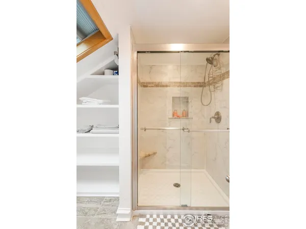 a bathroom with a shower and a sink