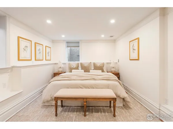 a bedroom with a bed and a painting on the wall