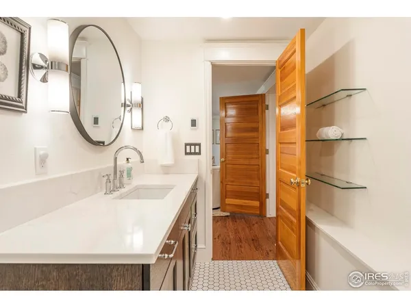 a bathroom with a sink a mirror and a shower