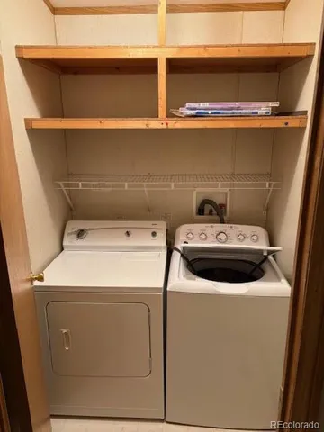 a kitchen with cabinets and white appliances