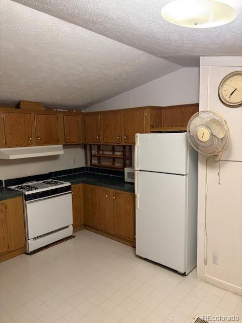 59505 County Rd Gg Moffat, CO 81143 - Photo 15 of 32 a kitchen with cabinets and white appliances