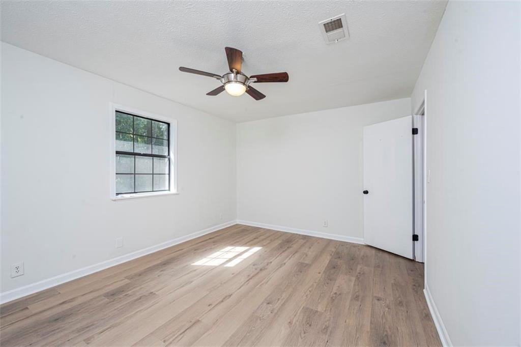 1752 Mitzi Court Duluth, GA 30097 - Photo 6 of 20 a view of empty room with wooden floor and fan