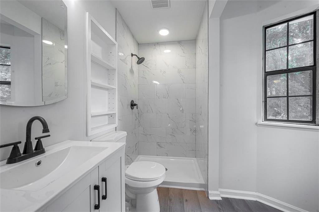 1752 Mitzi Court Duluth, GA 30097 - Photo 9 of 20 a bathroom with a sink toilet a mirror and shower