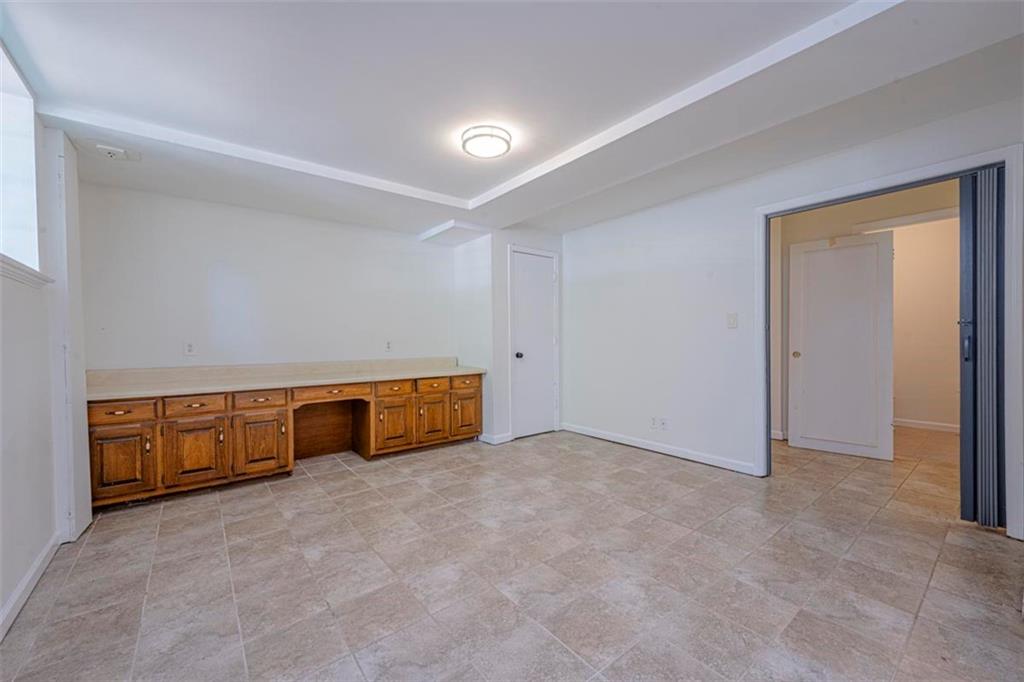 1752 Mitzi Court Duluth, GA 30097 - Photo 10 of 20 an empty room with a bench and dryer