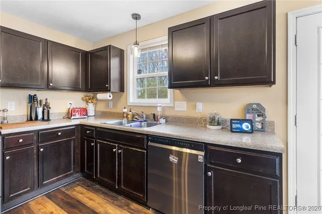 a kitchen with stainless steel appliances granite countertop a sink stove and cabinets
