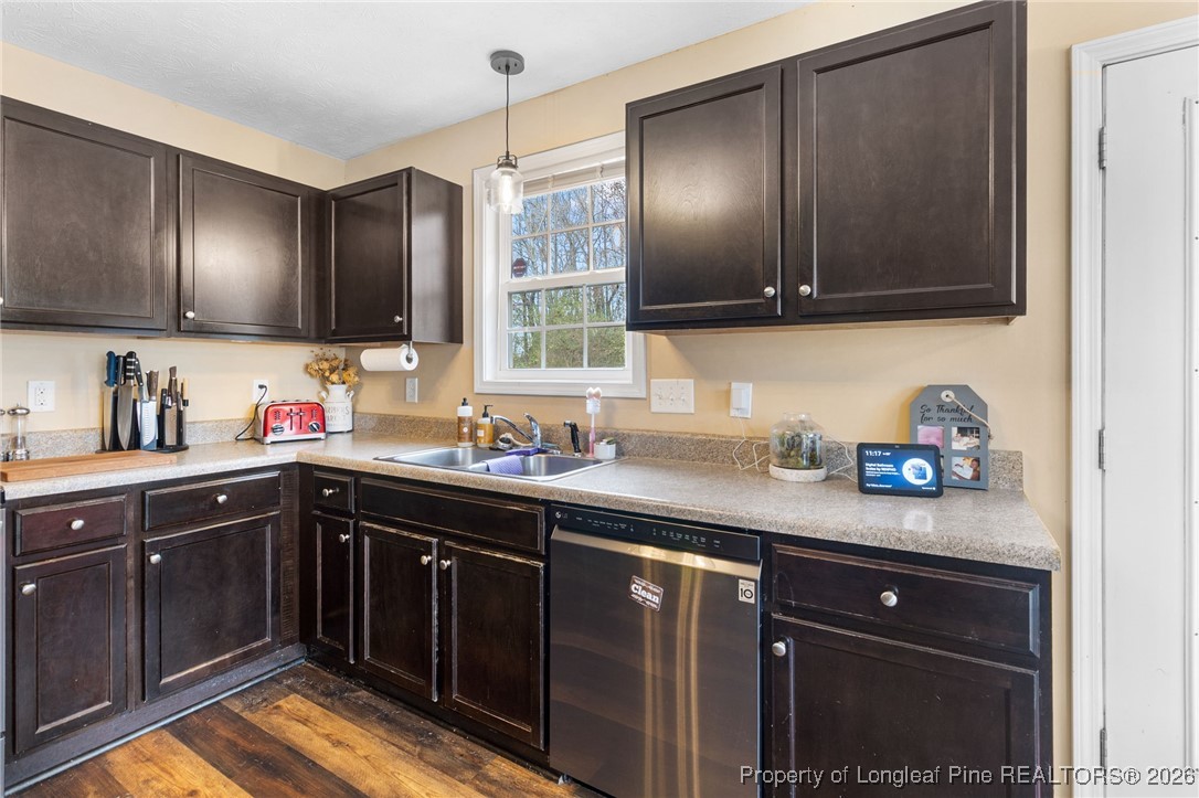 290 Mayor Court Raeford, NC 28376 - Photo 11 of 32 a kitchen with stainless steel appliances granite countertop a sink stove and cabinets