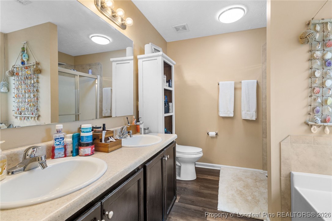 290 Mayor Court Raeford, NC 28376 - Photo 17 of 32 a bathroom with a double vanity sink toilet and mirror