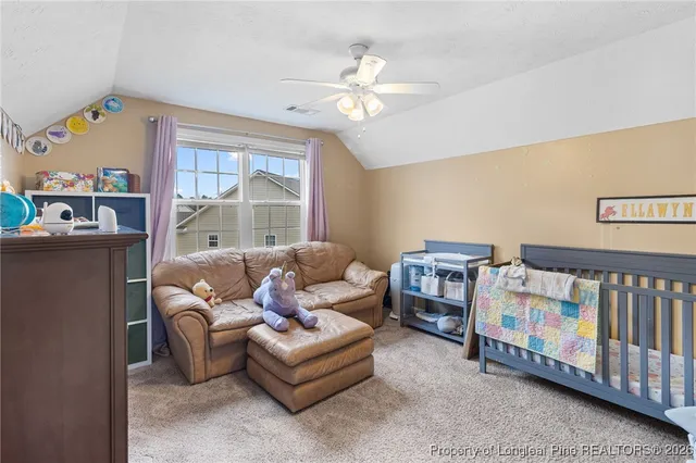 a living room with furniture a baby crib furniture a chandelier and a window