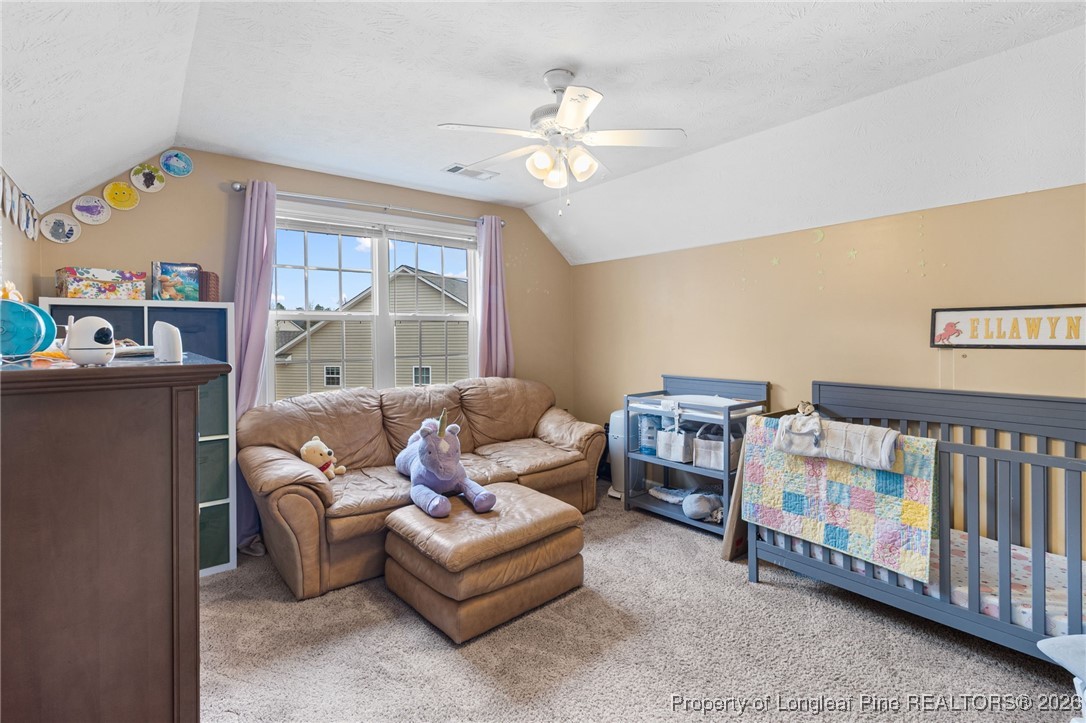 290 Mayor Court Raeford, NC 28376 - Photo 20 of 32 a living room with furniture a baby crib furniture a chandelier and a window