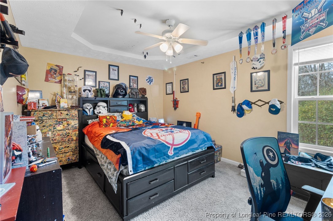 290 Mayor Court Raeford, NC 28376 - Photo 24 of 32 a bedroom with a bed and a chandelier