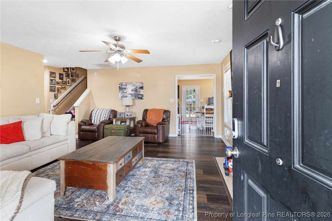 290 Mayor Court Raeford, NC 28376 - Photo 3 of 32 a living room with furniture a chandelier and a wooden floor