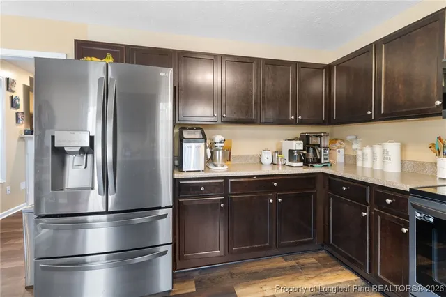 a kitchen with stainless steel appliances granite countertop a refrigerator and a sink